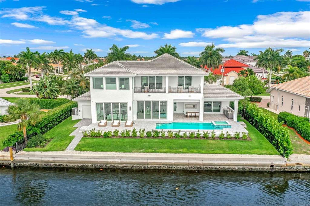 1608 Windmill Avenue Marco Island, FL 34145 - Photo 1 of 34 a front view of a house with a yard