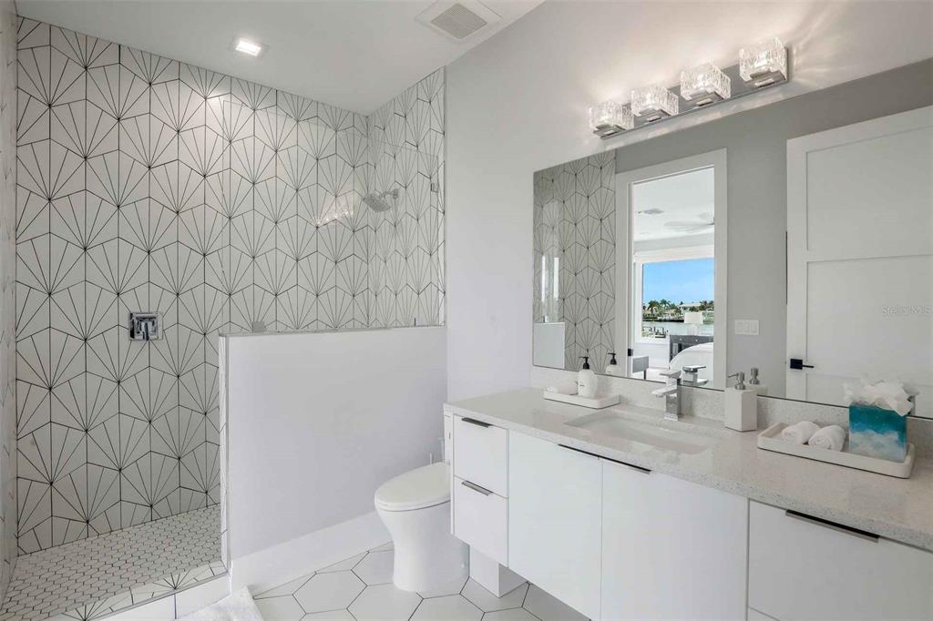 1608 Windmill Avenue Marco Island, FL 34145 - Photo 14 of 34 a bathroom with a granite countertop sink and a mirror