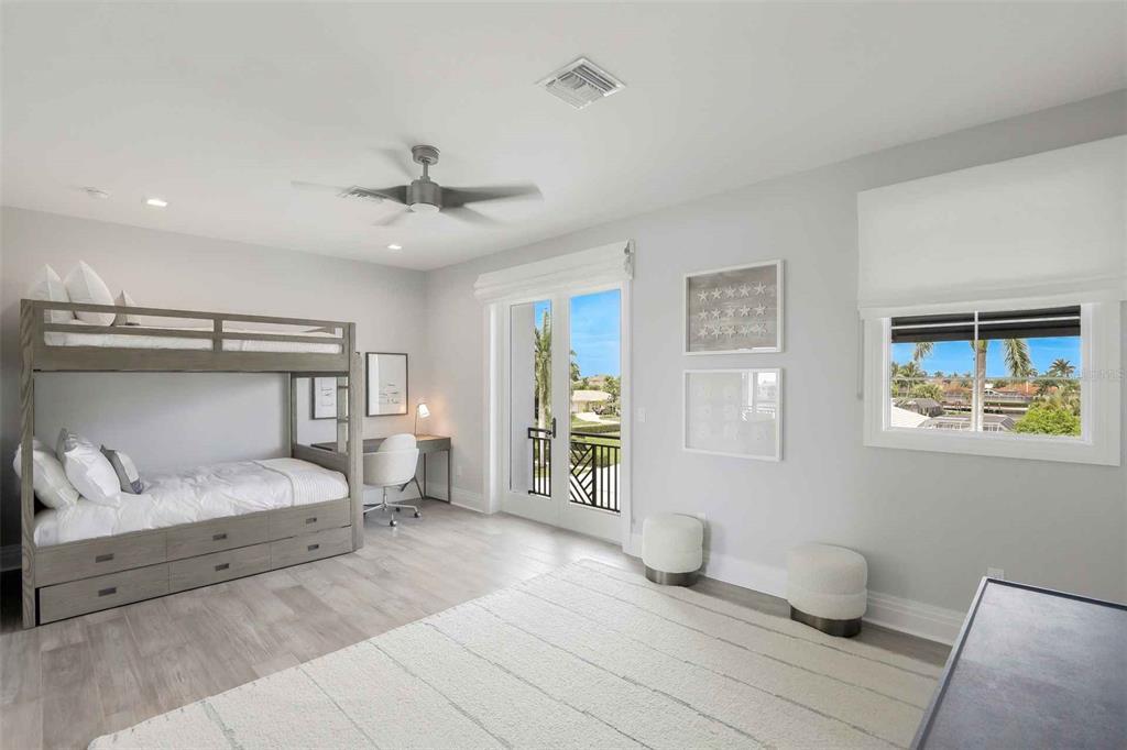 1608 Windmill Avenue Marco Island, FL 34145 - Photo 17 of 34 a bedroom with a large bed and a chandelier