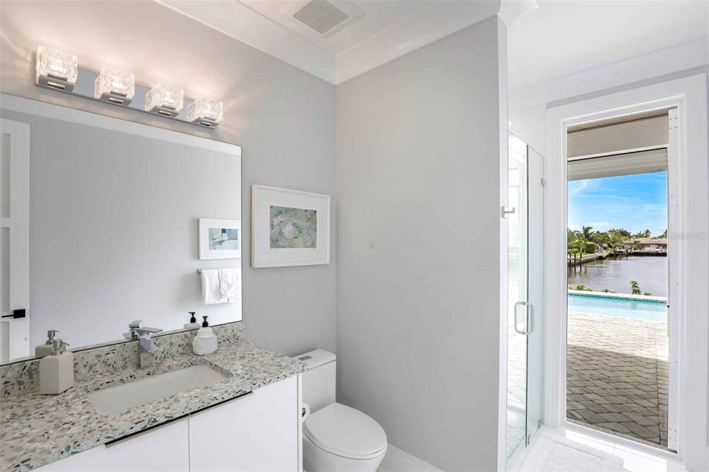 1608 Windmill Avenue Marco Island, FL 34145 - Photo 18 of 34 a bathroom with a granite countertop sink toilet and mirror