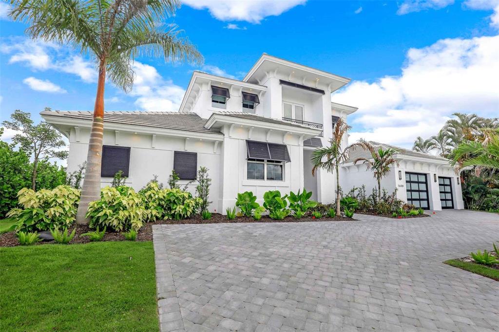 1608 Windmill Avenue Marco Island, FL 34145 - Photo 34 of 34 a front view of a house with a garden
