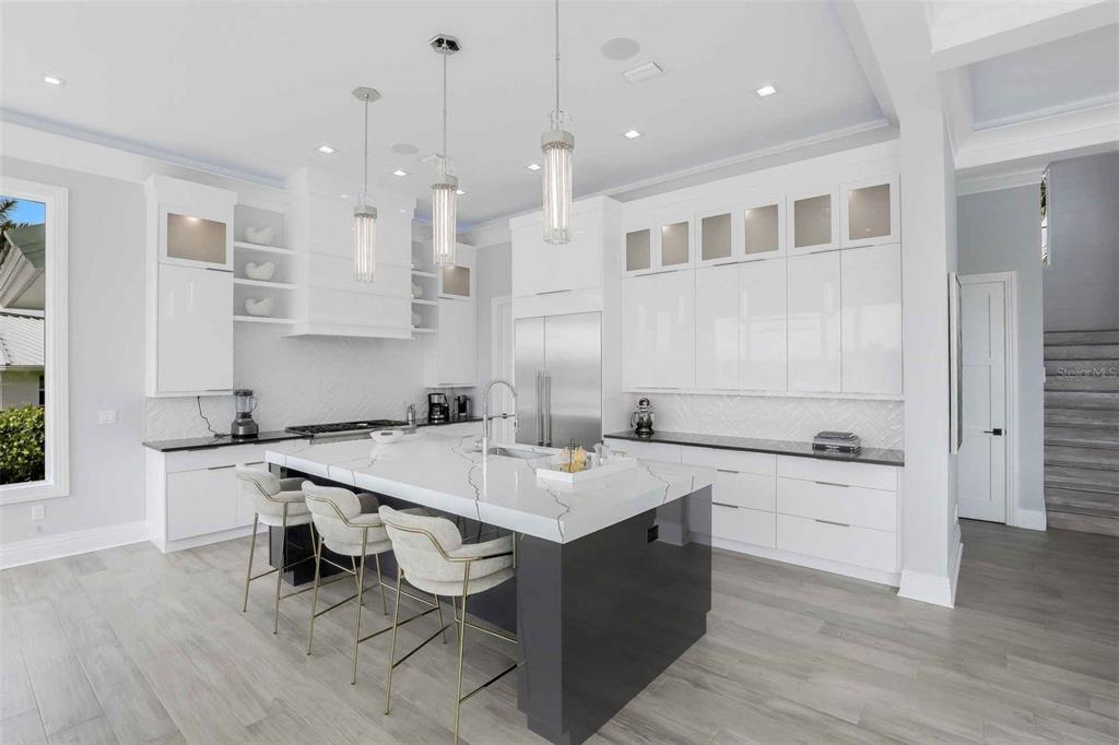 1608 Windmill Avenue Marco Island, FL 34145 - Photo 5 of 34 a kitchen with a sink a stove a refrigerator and cabinets