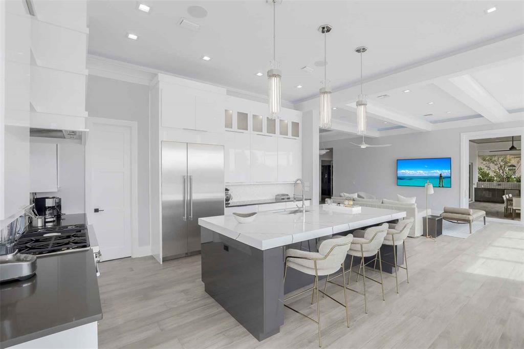 1608 Windmill Avenue Marco Island, FL 34145 - Photo 6 of 34 a large kitchen with a table and chairs in it