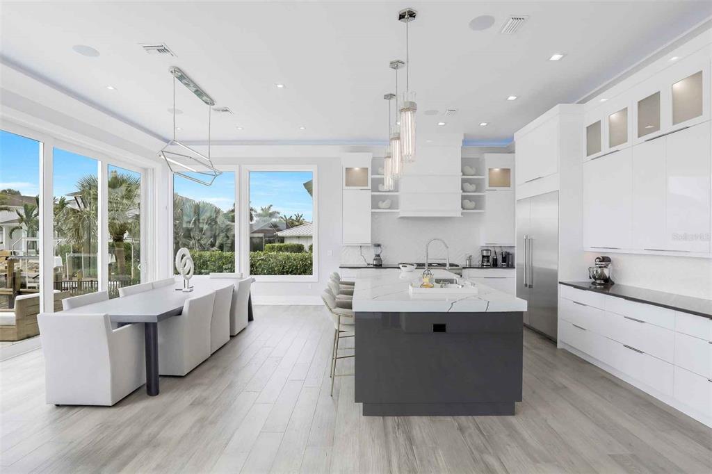 1608 Windmill Avenue Marco Island, FL 34145 - Photo 7 of 34 a large white kitchen with a large window a sink appliances and cabinets