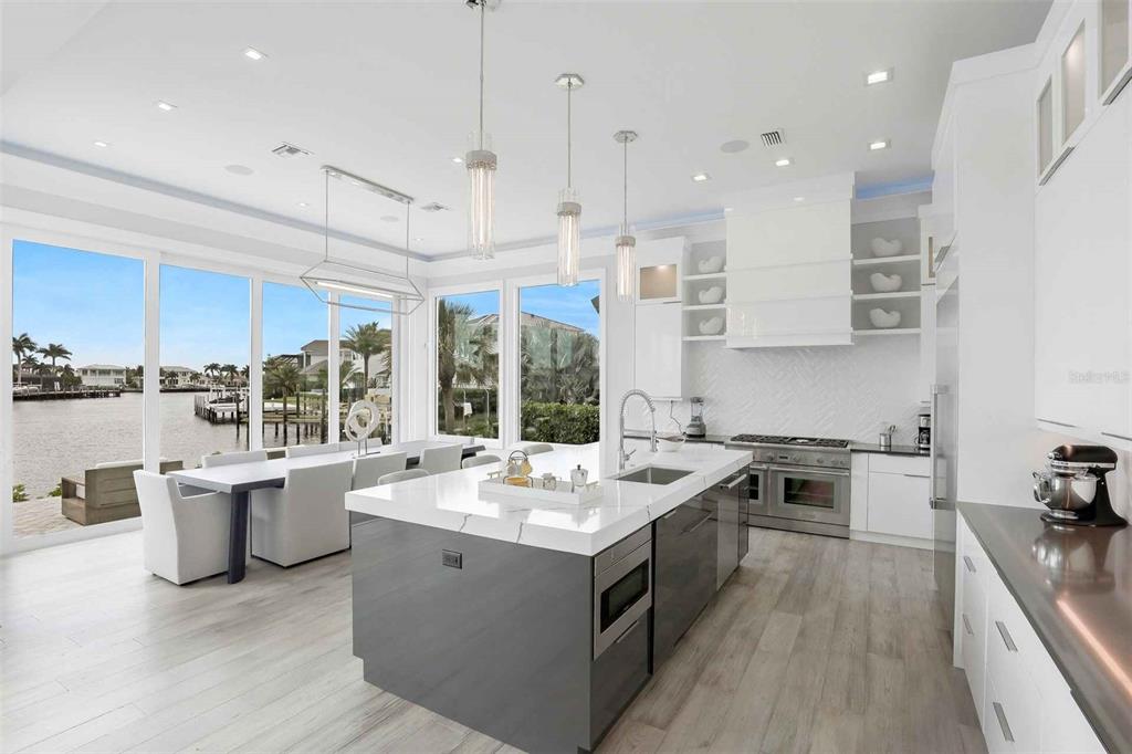 1608 Windmill Avenue Marco Island, FL 34145 - Photo 8 of 34 a open kitchen with stainless steel appliances granite countertop a sink a stove and a wooden floors