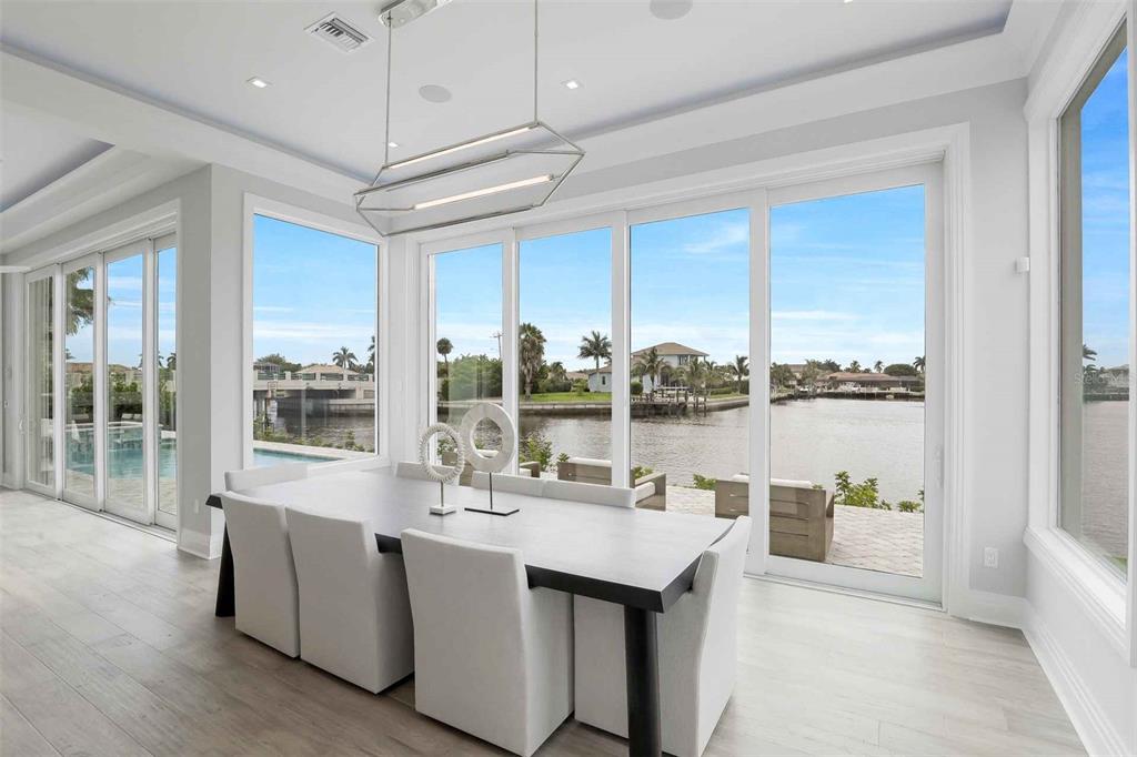 1608 Windmill Avenue Marco Island, FL 34145 - Photo 10 of 34 a dining hall with stainless steel appliances kitchen island granite countertop a sink and cabinets