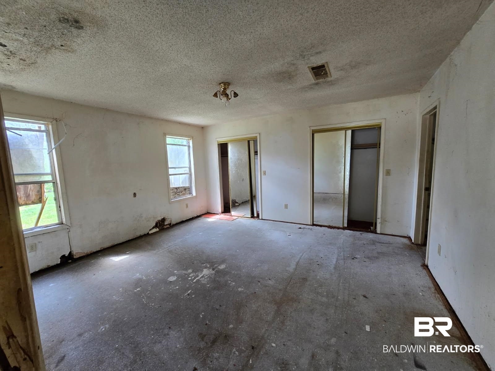 4072 Appleton Road Brewton, AL 36426 - Photo 6 of 7 Unfurnished room with plenty of natural light and a textured ceiling