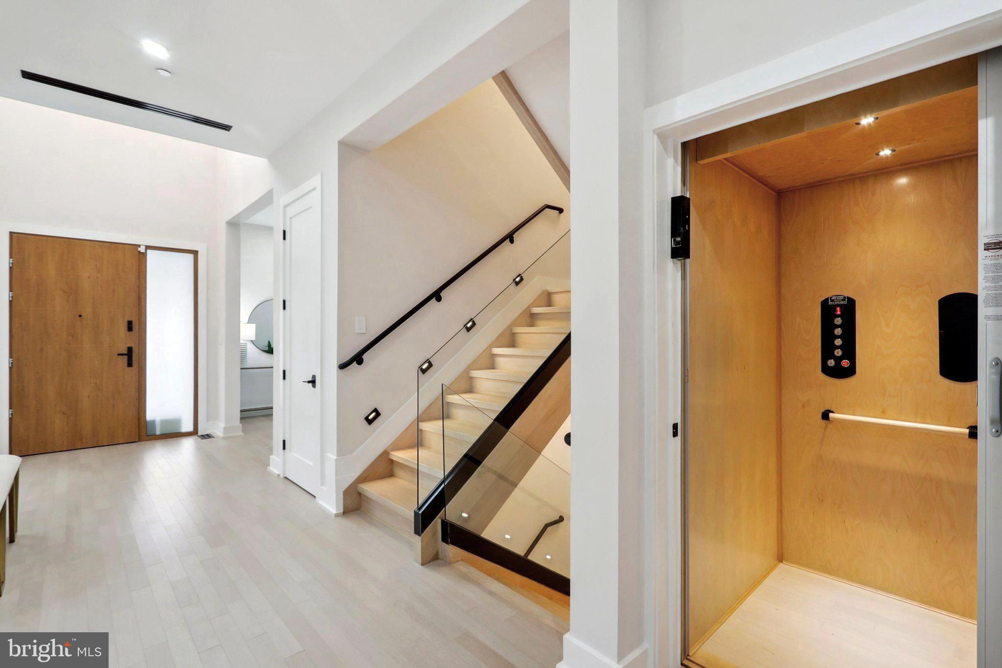 4920 Loughboro Road Northwest Washington, DC 20016 - Photo 8 of 41 a view of an entryway with wooden floor and a livingroom