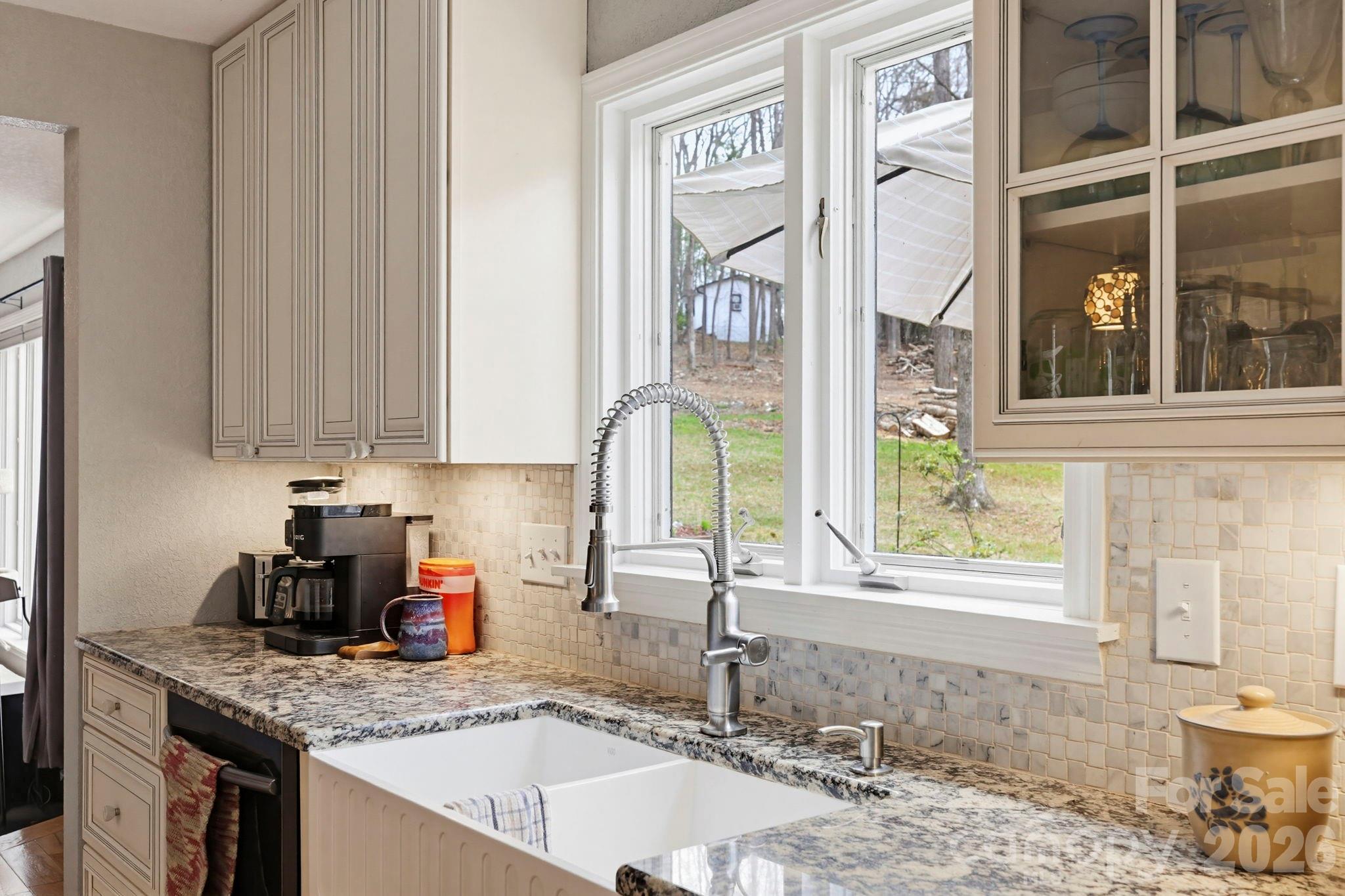 27 Spring Hill Circle Arden, NC 28704 - Photo 13 of 47 a kitchen with a granite countertop sink and a window