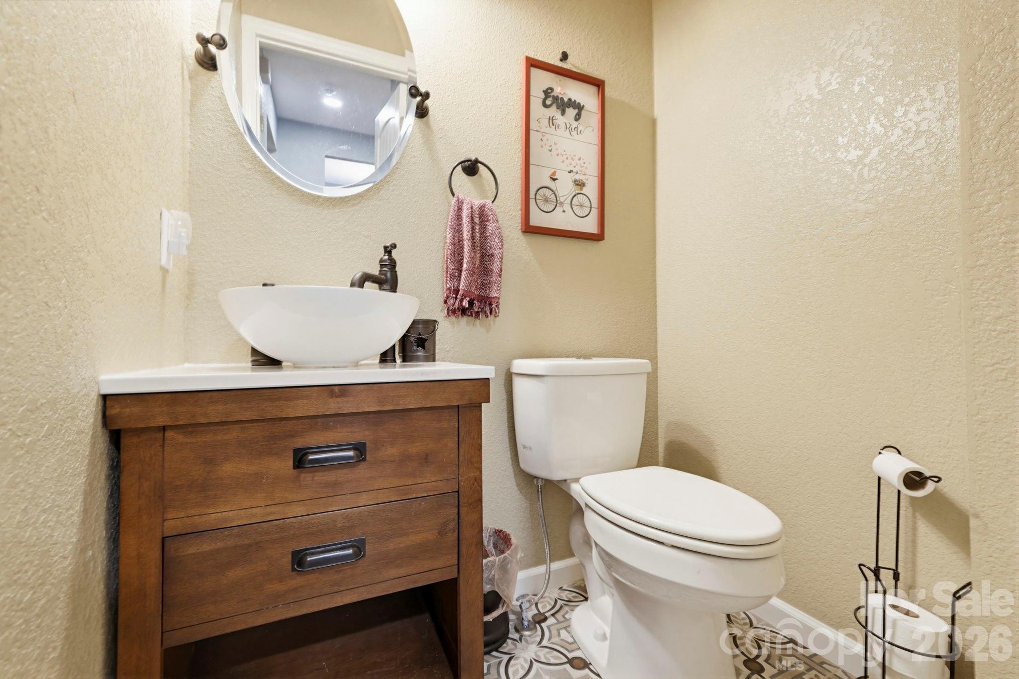 27 Spring Hill Circle Arden, NC 28704 - Photo 16 of 47 a bathroom with a toilet a sink and mirror