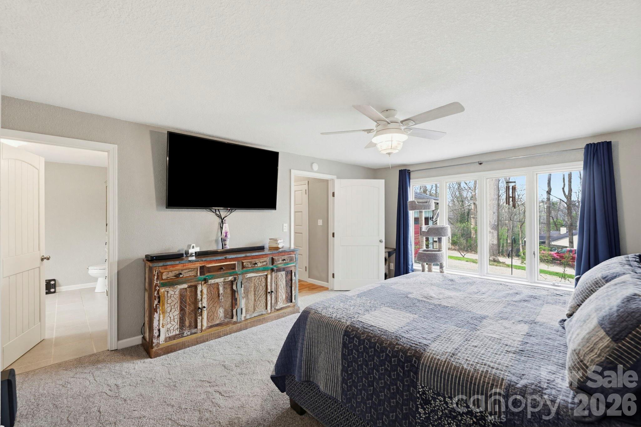 27 Spring Hill Circle Arden, NC 28704 - Photo 18 of 47 a bedroom with a bed and a flat screen tv