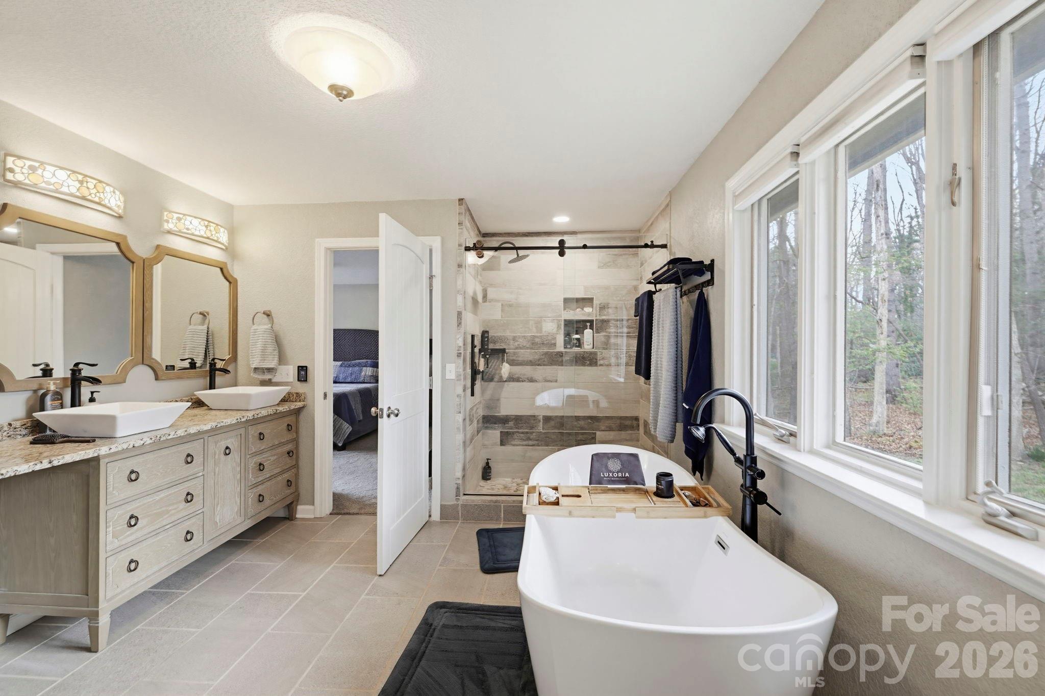 27 Spring Hill Circle Arden, NC 28704 - Photo 21 of 47 a bathroom with a tub sink toilet and mirror