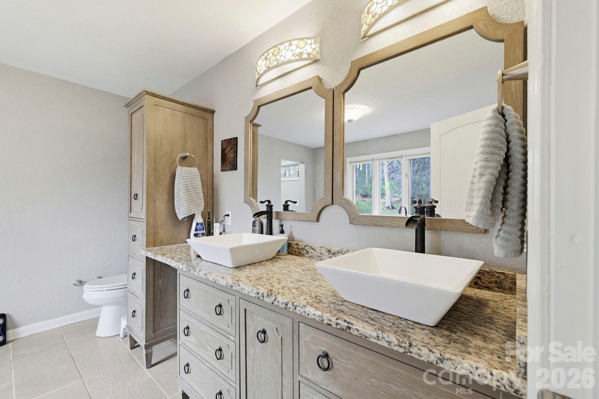 27 Spring Hill Circle Arden, NC 28704 - Photo 22 of 47 a bathroom with a granite countertop sink mirror and toilet