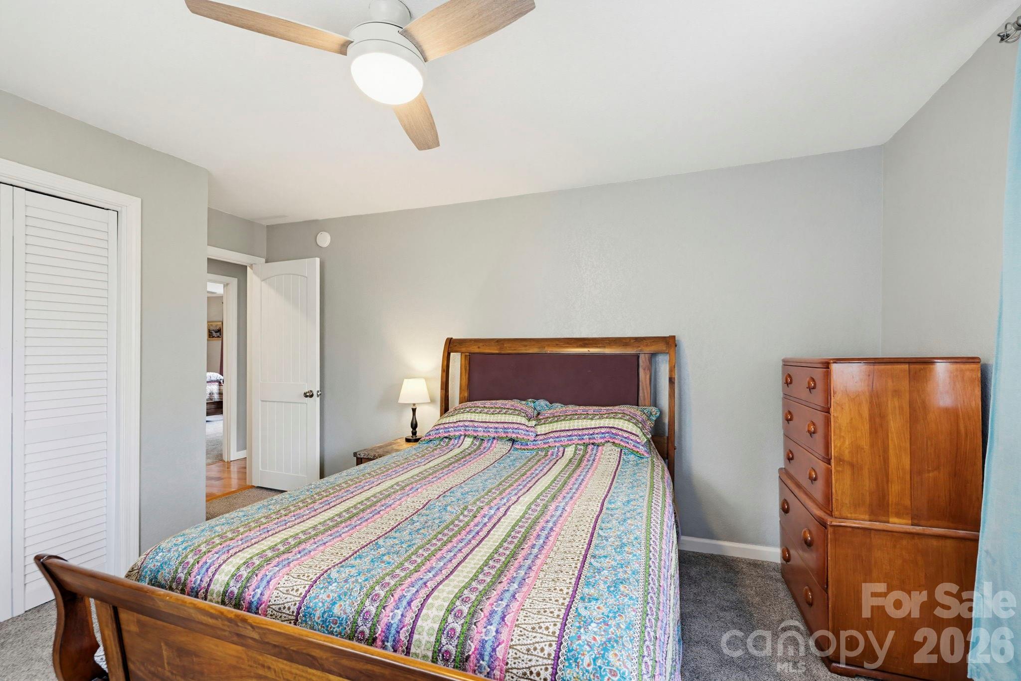 27 Spring Hill Circle Arden, NC 28704 - Photo 30 of 47 a bedroom with a bed and a refrigerator