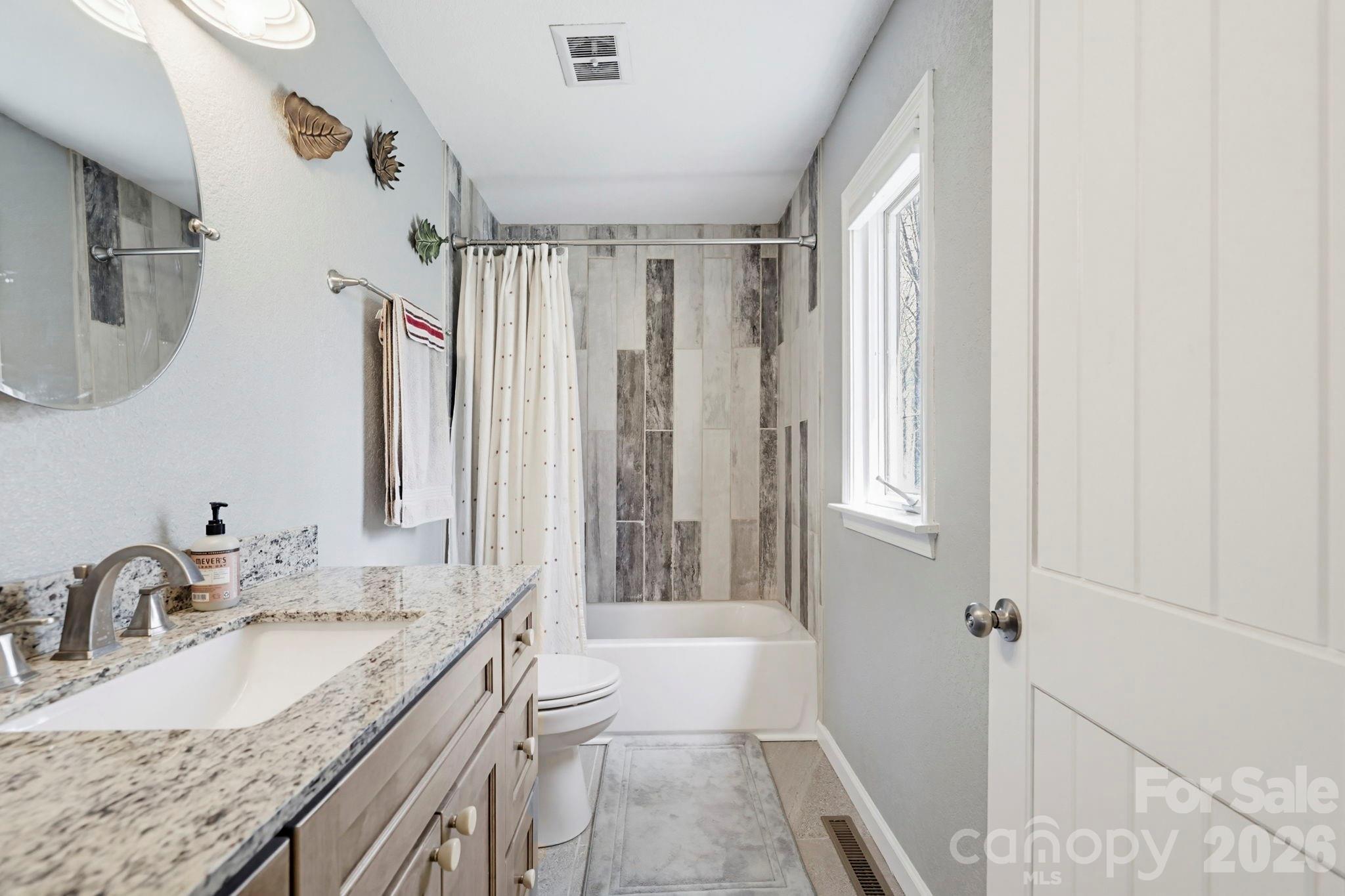 27 Spring Hill Circle Arden, NC 28704 - Photo 31 of 47 a bathroom with a granite countertop sink and a mirror