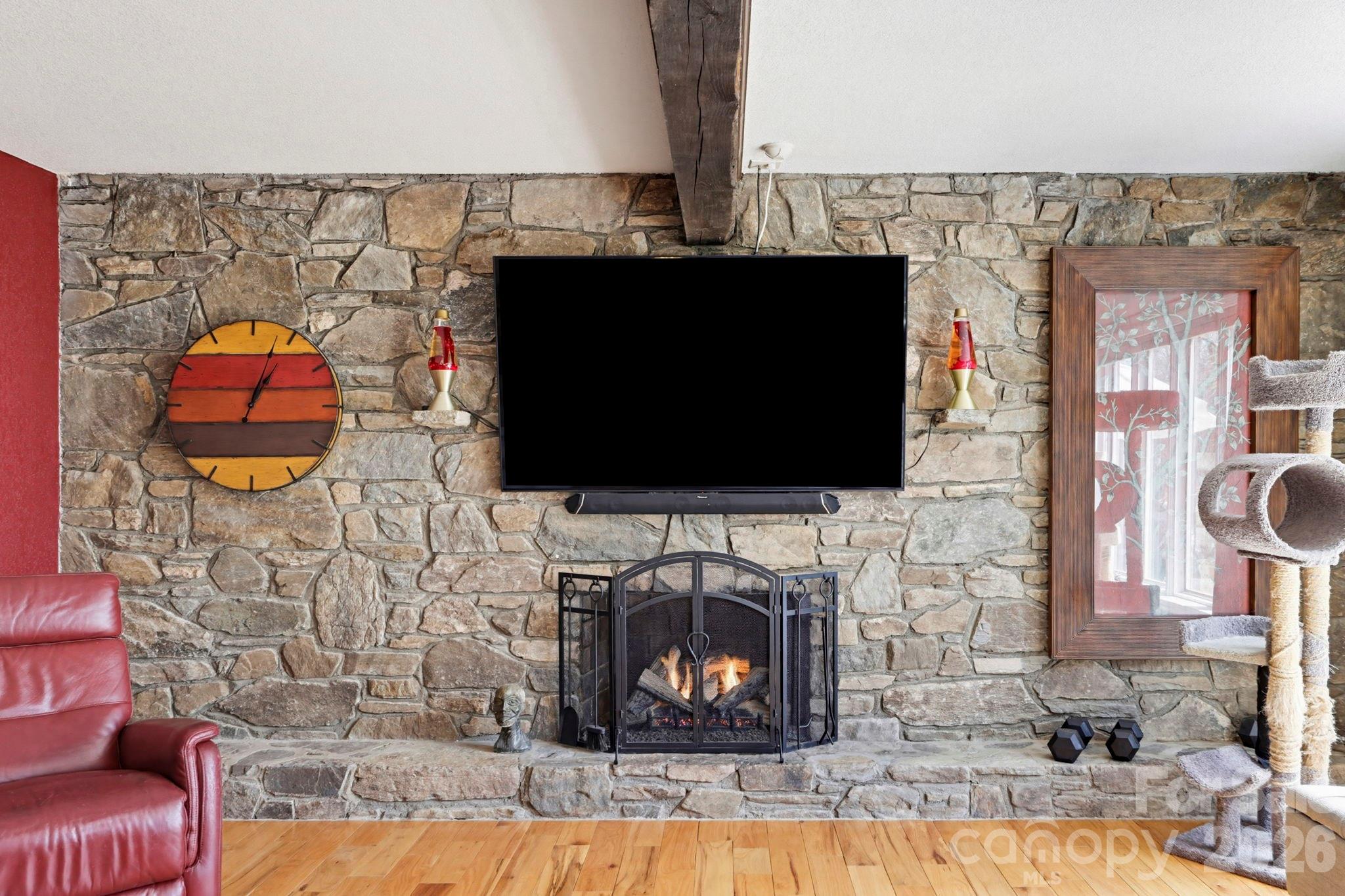 27 Spring Hill Circle Arden, NC 28704 - Photo 7 of 47 a living room with a fireplace and a flat screen tv