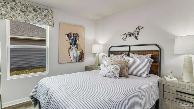 a bedroom with a large bed and a window