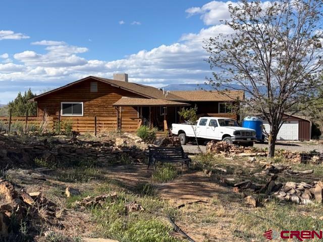 51233 Carnation Road Delta, CO 81416 - Photo 2 of 21 a front view of a house with garden