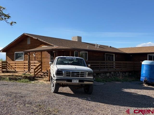 51233 Carnation Road Delta, CO 81416 - Photo 3 of 21 a front view of a house with a garden