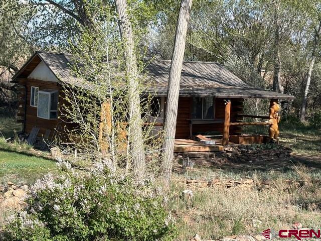 51233 Carnation Road Delta, CO 81416 - Photo 10 of 21 a view of a house with a small yard and large tree