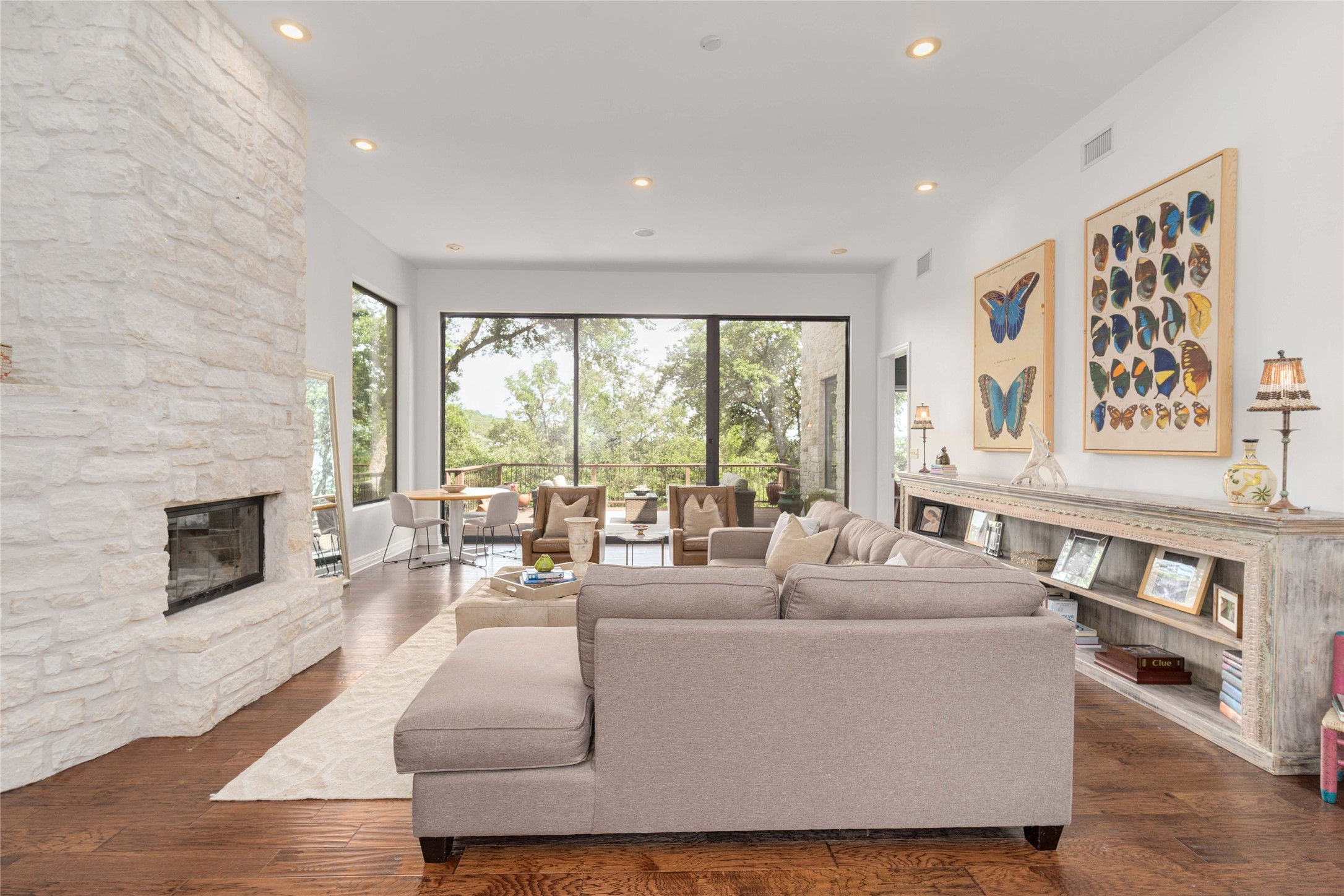 2102 Paisano Road Austin, TX 78746 - Photo 4 of 26 Living room featuring a fireplace, dark wood-style flooring, and recessed lighting