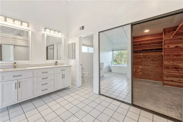 a bathroom with a granite countertop sink mirror and shower