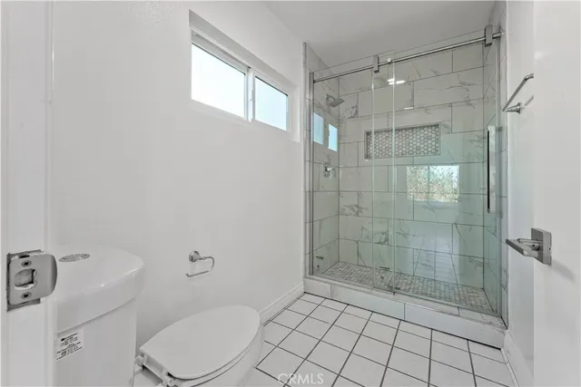 a bathroom with a shower a toilet and sink