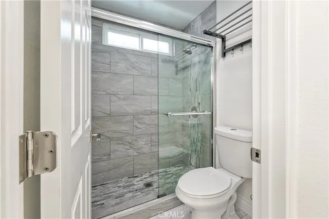 a white toilet sitting next to a bathroom sink