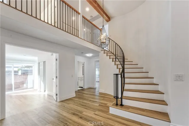 a view of entryway and hall with wooden floor