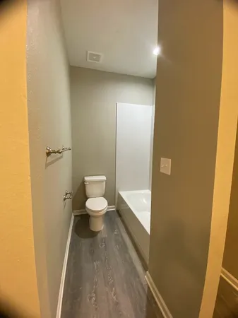 a bathroom with a toilet a sink and bathtub