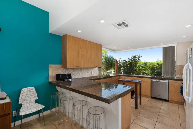 a kitchen with stainless steel appliances granite countertop a sink and cabinets