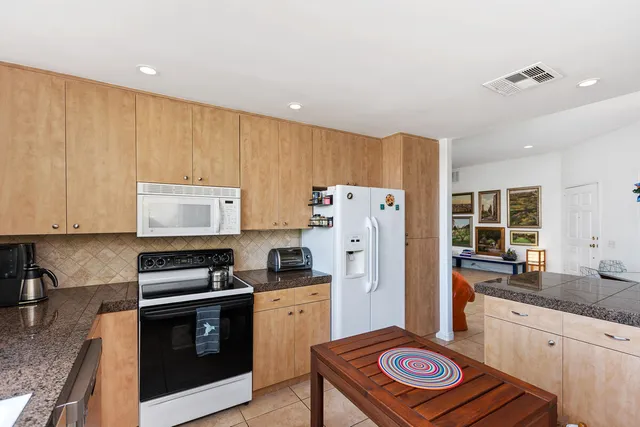 a kitchen with refrigerator and cabinets