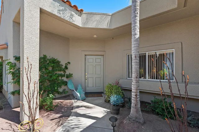 a house with potted plants in front of door