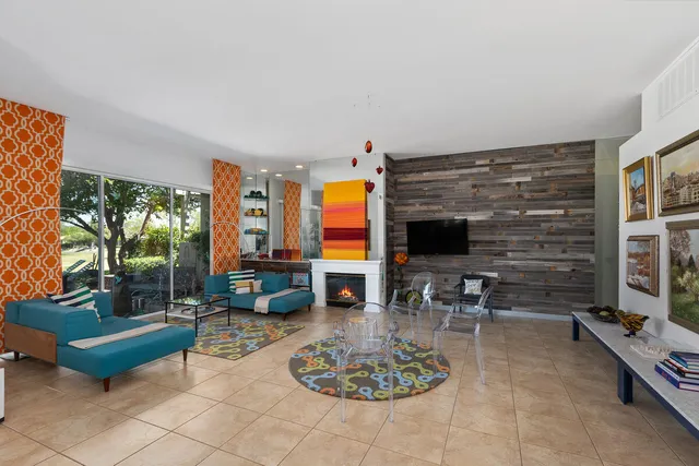 a living room with furniture a rug and a fireplace