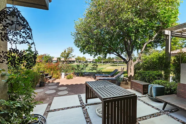 a view of a patio with table and chairs and potted plants