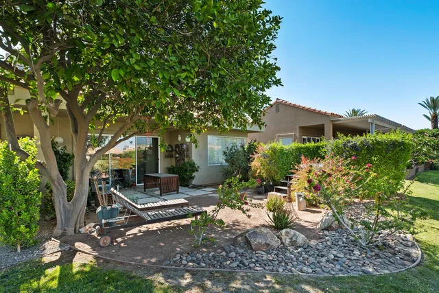 a view of a patio with table and chairs and potted plants