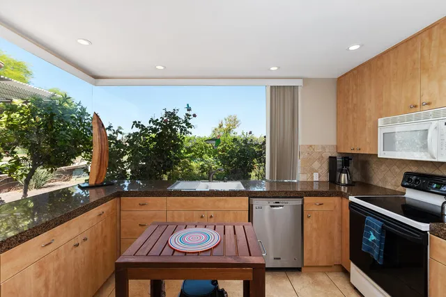 a kitchen with a sink and a stove top oven