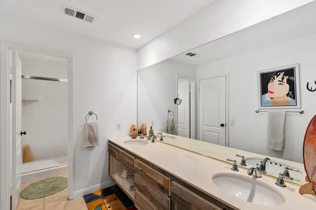 a bathroom with a double vanity sink and a mirror