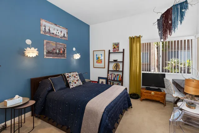 a bedroom with a bed and a desk