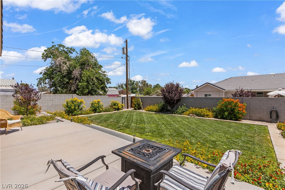 3020 Hannig Street Logandale, NV 89021 - Photo 61 of 75 A spacious backyard awaits, featuring a welcoming patio and a lush green lawn.