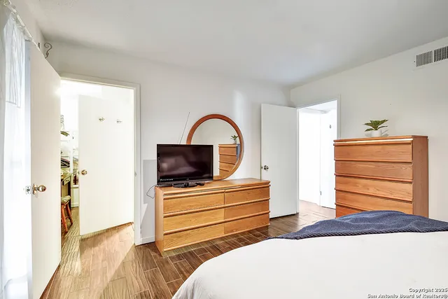 a bedroom with a bed and a dresser