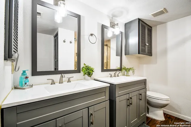 a bathroom with a sink double vanity and a mirror