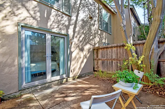a view of a patio with table and chairs and potted plants