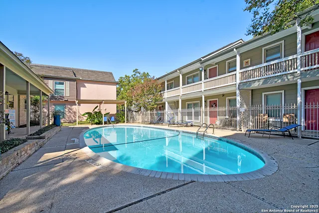 a view of a house with swimming pool and sitting area