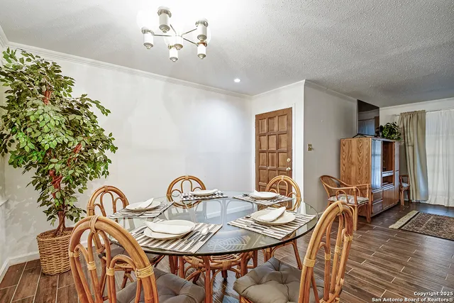 a view of a dining room with furniture and chandelier