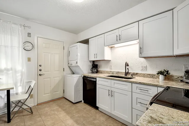 a kitchen with a sink cabinets and window