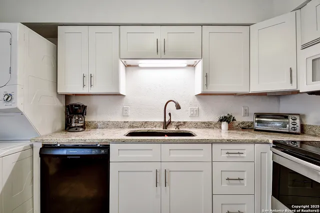 a kitchen with appliances cabinets and a sink