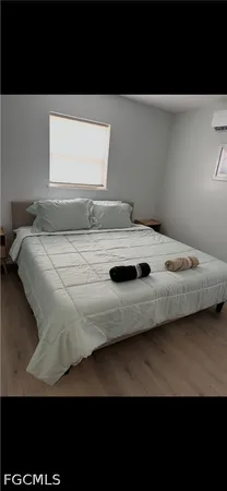 a bedroom with a bed and window