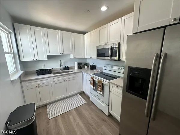 a kitchen with a refrigerator stove and sink
