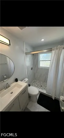 a bathroom with a sink a toilet and a shower